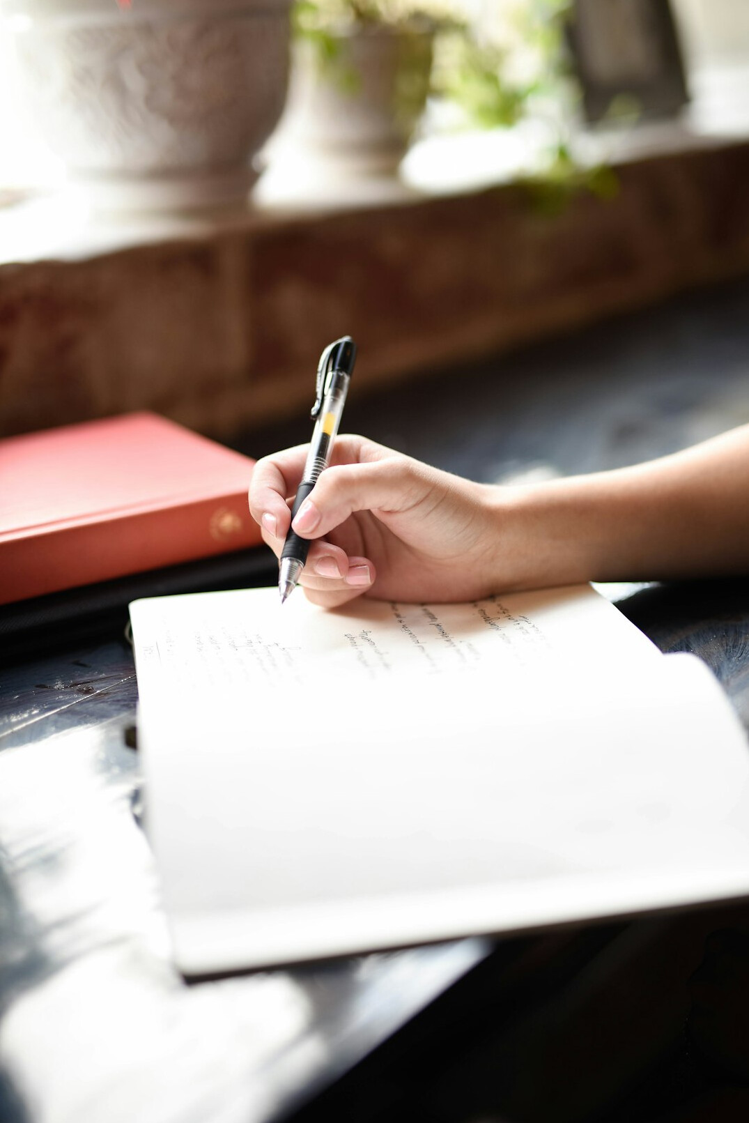 person writing in journal