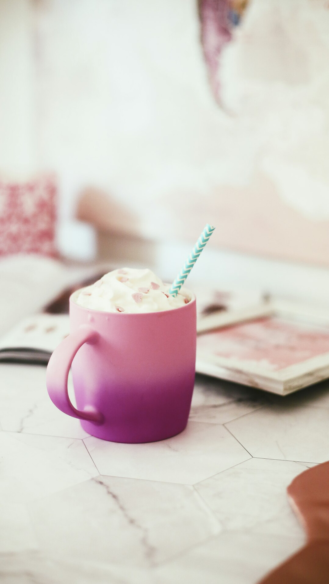Open journal notebook with pen, coffee cup and small plant on a wooden desk